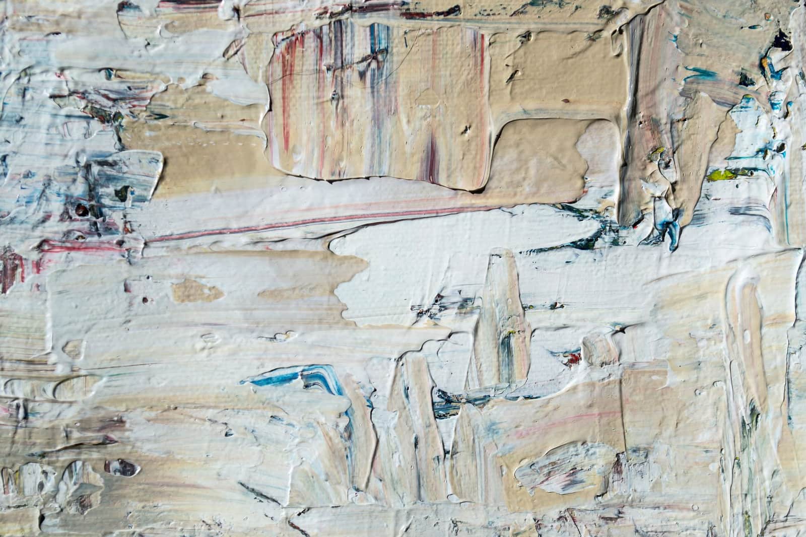 Close-up of textured abstract painting with layered acrylic paint in neutral tones.